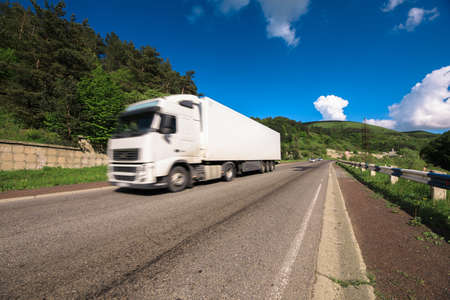 Arriving white truck on the roadの写真素材