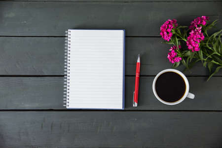 notepad with coffee and flower on deskの写真素材