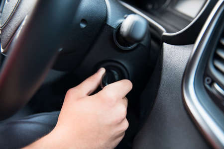 man inserting key in car ignition lockの写真素材