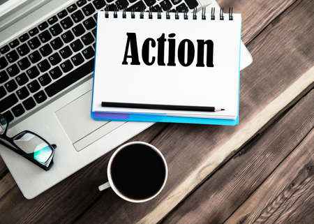 action text on notepd with keybord on deskの写真素材