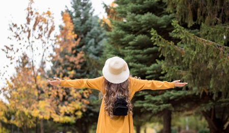 young happy woman in autumn gardenの写真素材