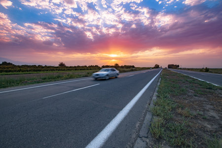 car on road at the sunsetの写真素材