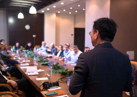 Speaker Giving a Talk at Business Meeting in the hallの写真素材