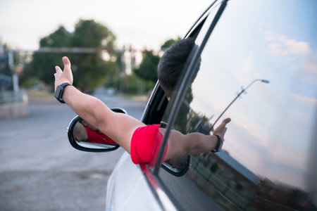 angry man inside car in streetの写真素材