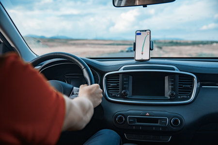 Man hand using GPS navigation inside carの写真素材