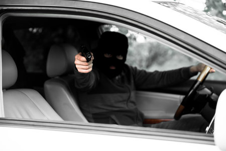 man hand holding gun in carの写真素材