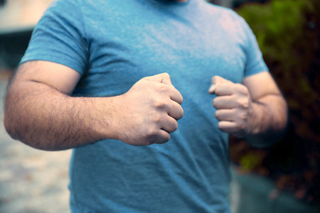 angry man fists in street backgroundの写真素材