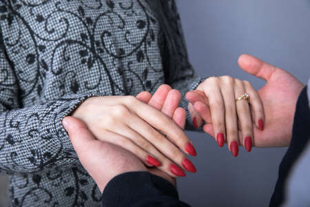 Man and woman hand in hand on gray backgroundの写真素材