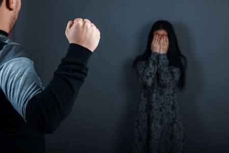 Man beating up his wife illustrating domestic violenceの写真素材