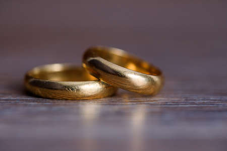 gold wedding rings on the table backgroundの写真素材