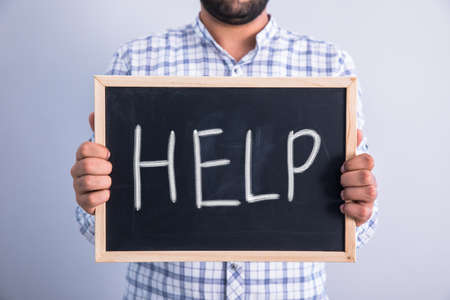 young man hand help on chalkboardの写真素材