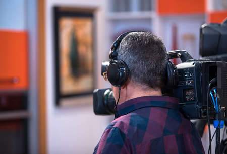 professional cameraman - covering on event with a videoの写真素材