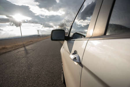 white car in road under abstract sky backgroundの写真素材