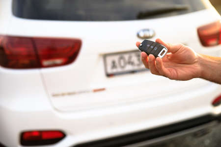 man hand key with car in streetの写真素材