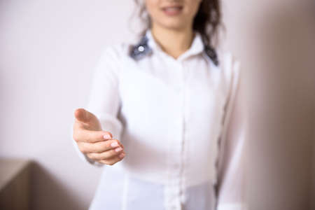 happy woman extend your hand on white backgroundの写真素材
