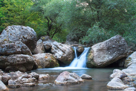Beautiful waterfall in the green trees Forrest