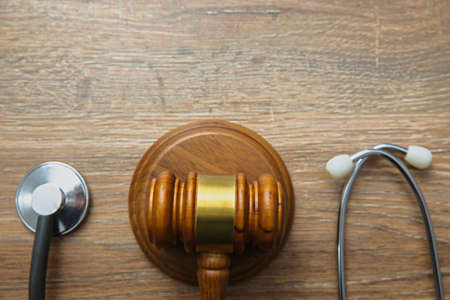 stethoscope and wooden judge on the tableの写真素材