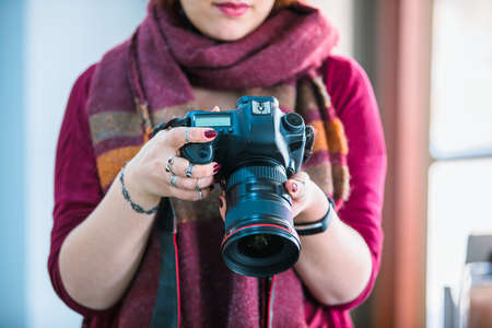 Young woman professional photographer hand cameraの写真素材