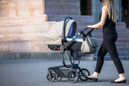 woman and stroller in the street background