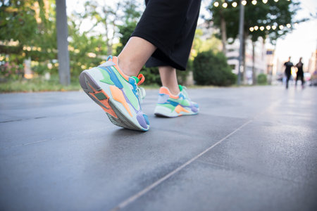 woman feet sport shoes walking in streetの写真素材