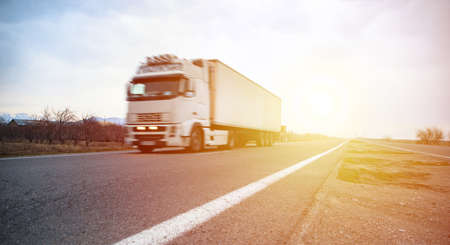white truck in road at the sunsetの写真素材