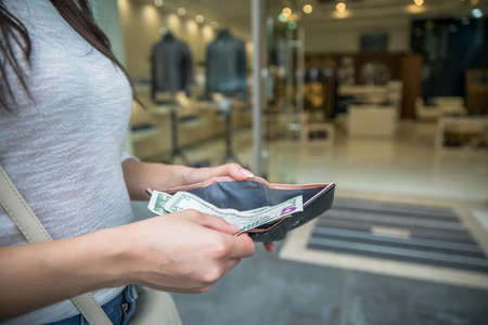 woman hand money and wallet in street