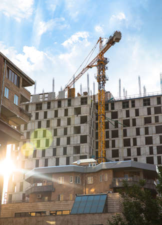 Crane and high concrete residential building