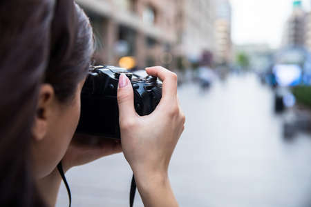 woman hand camera in the street background