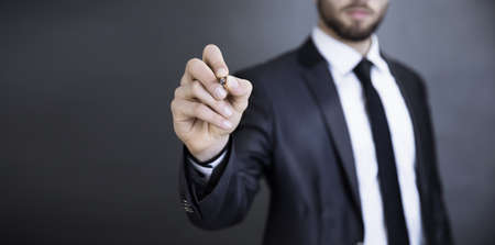 business man hand pen in the screenの写真素材