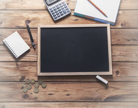 chalkboard and chalk with stationary on the tableの写真素材
