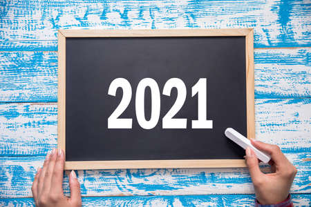 woman and chalk with 2021 in boardの写真素材
