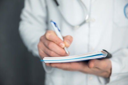 young doctor hand pen and notebookの写真素材