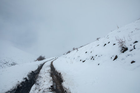 snowy road in mountain and foggy