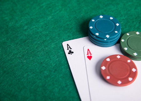 Pair of aces with poker chips on the poker table