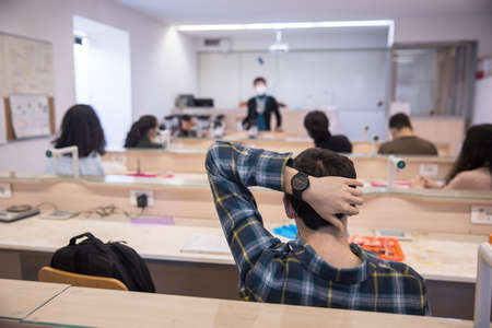 Group of students study with professor in modern school classroomの写真素材