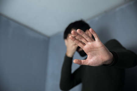 sad man hand stop signの写真素材