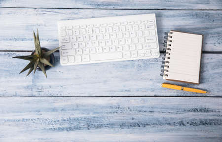 keyboard with notebook on the office desk