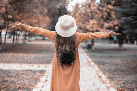 happy young woman in autumn parkの写真素材