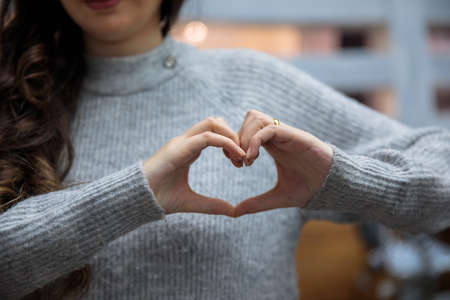 the young woman hand heart signの写真素材