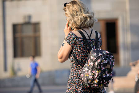 woman in bag walking in street