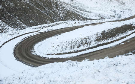 bends road in the snowy mountainの写真素材