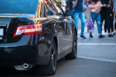 car with people in city crosswalk