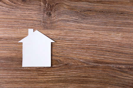 paper house model on wooden backgroundの写真素材