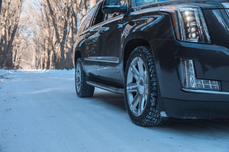 Car with winter tire on snowy roadの写真素材