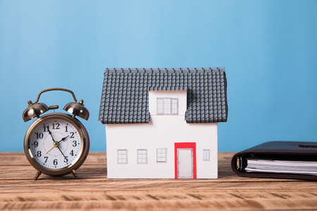 house model with clock and notebookの写真素材