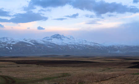 landscape with snowy mountain at the sunsetの写真素材
