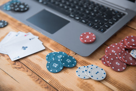 Gambling chips and playing cards on keyboard