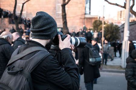man photographer hand camera in the demonstration