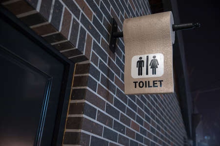 Man and lady toilet sign on concrete wall backgroundの写真素材