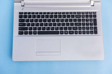 white computer on the blue table